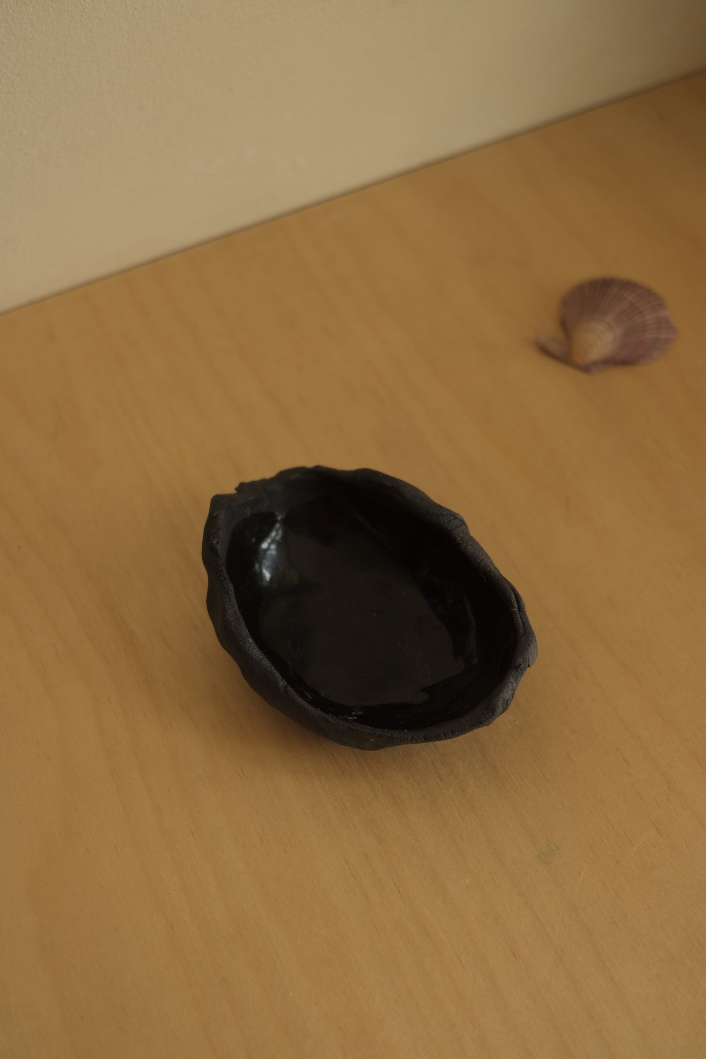 uneven medium trinket dish in black clay