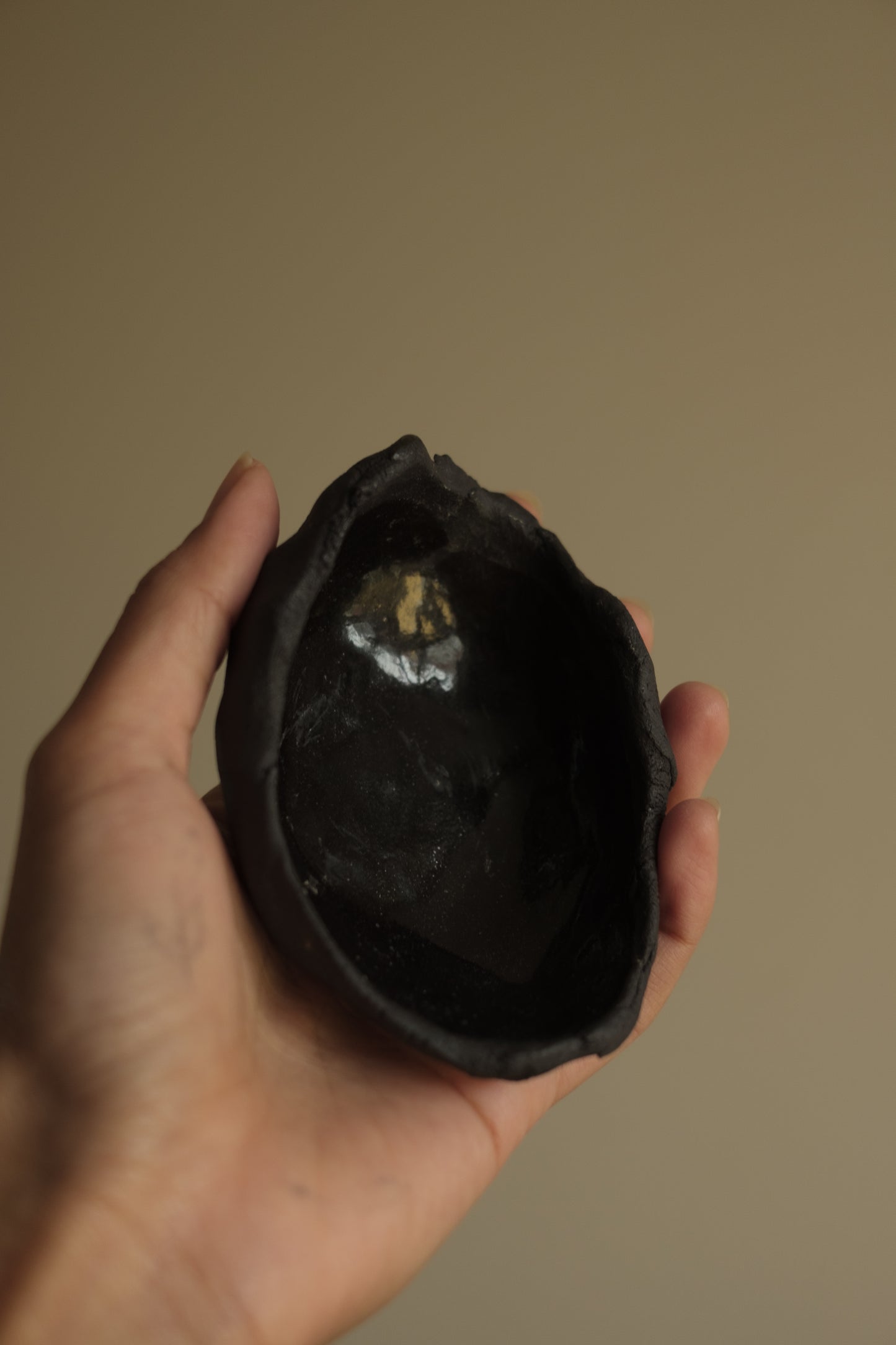 uneven medium trinket dish in black clay