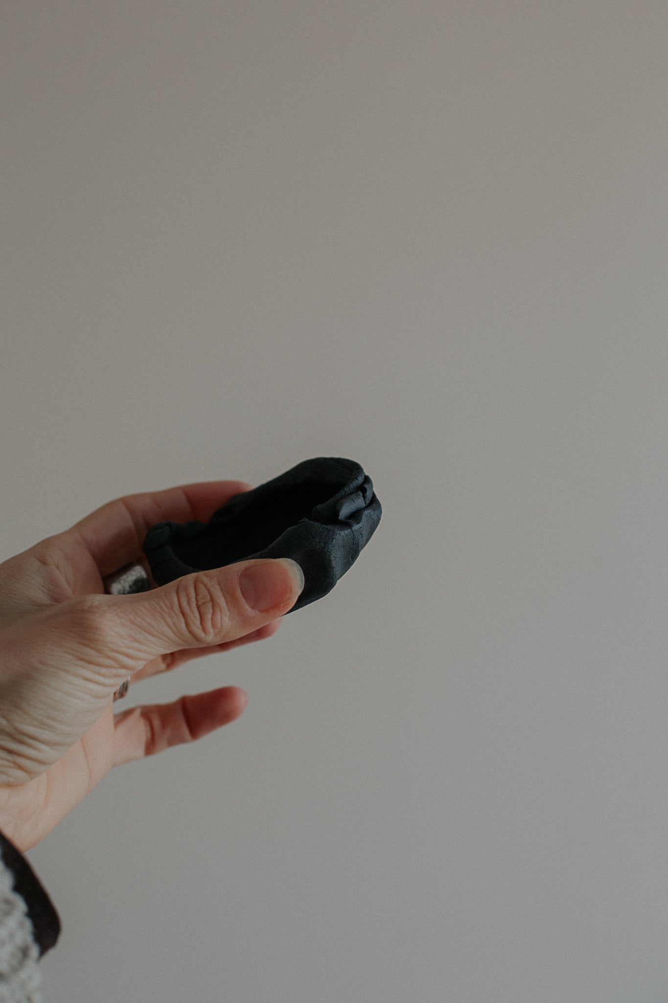 uneven small trinket dish in black clay by linda bredenbekk