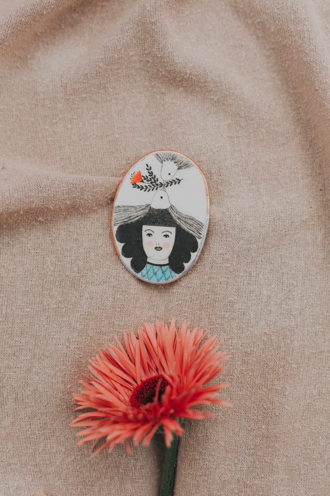 girl with art in hair brooch