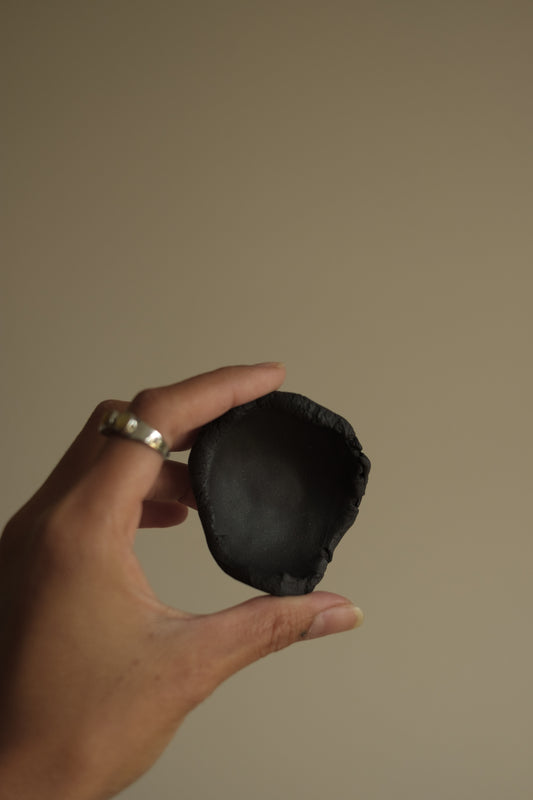 uneven small trinket dish in black clay