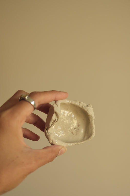 uneven trinket dish in beige clay