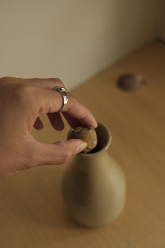 ceramic bottle with foraged stone cork