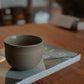 200 ml cup in warm sand by linda bredenbekk