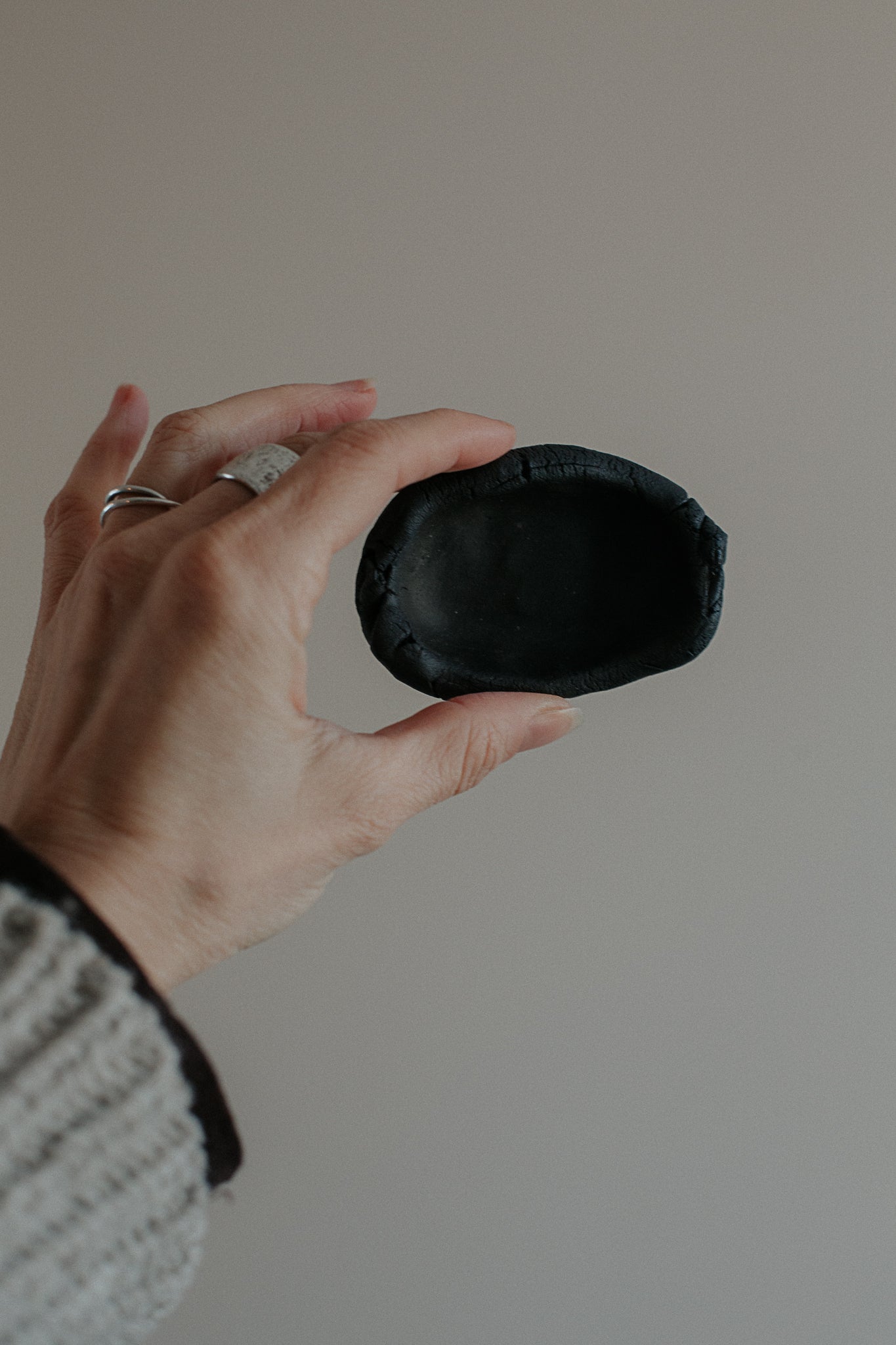 uneven small trinket dish in black clay by linda bredenbekk