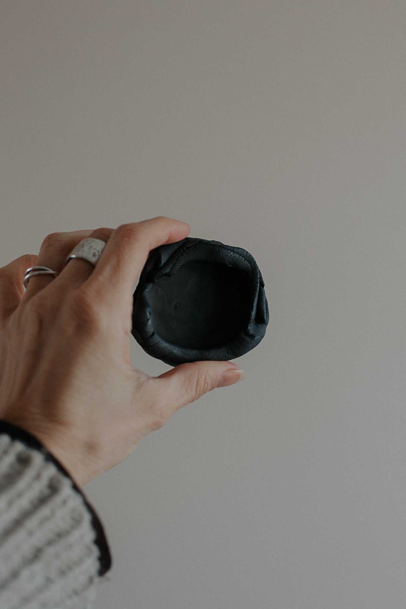 uneven small trinket dish in black clay by linda bredenbekk