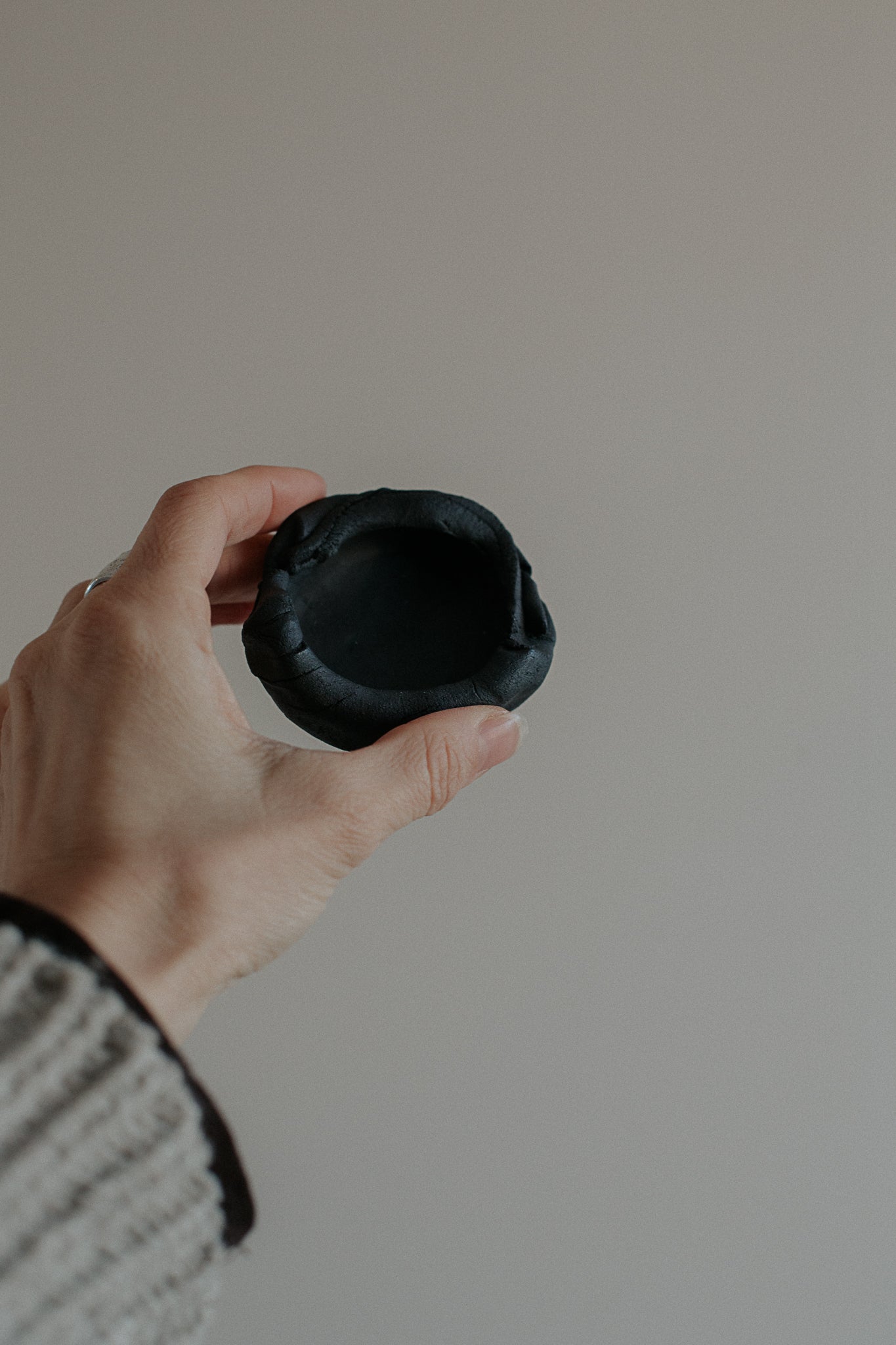 uneven small trinket dish in black clay by linda bredenbekk