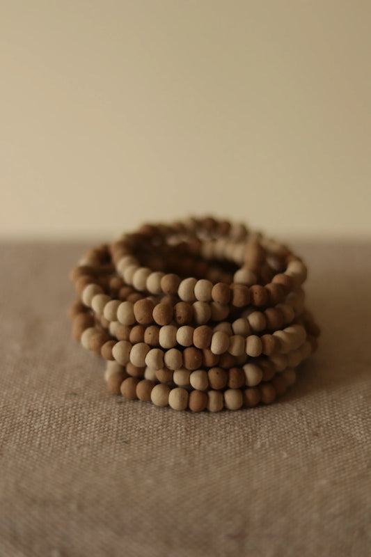 organica clay bead bracelet in sediment