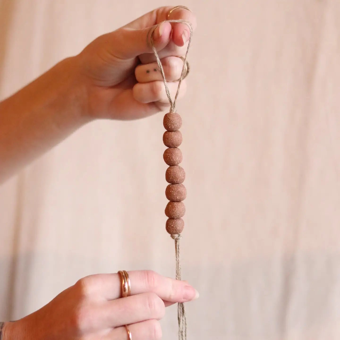 gathered red earth beaded ornament